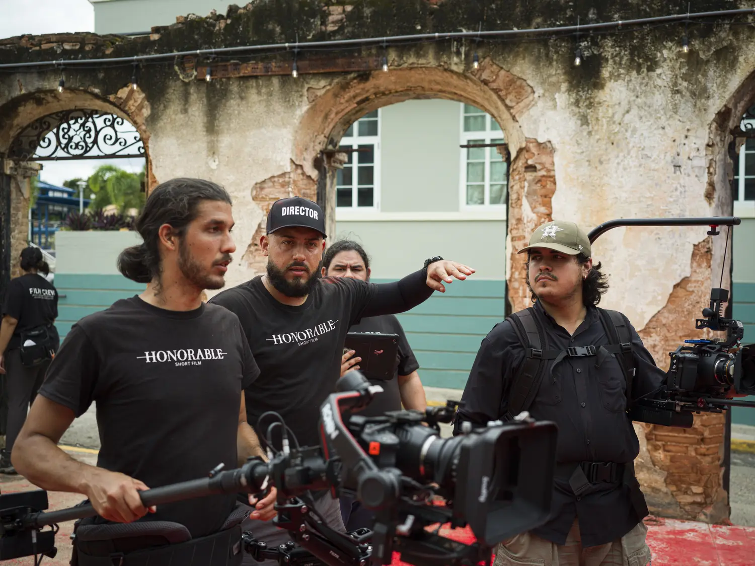 Camera crew working inside a roofless colonial ruin